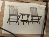 a drawing of two chairs and a table on a piece of paper
