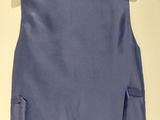 a close up of a blue vest hanging on a wall