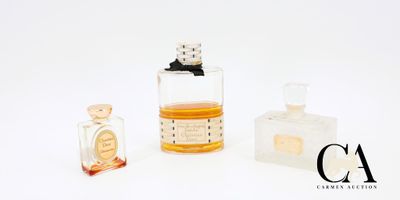 trois flacons de parfum posés l'un à côté de l'autre sur une surface blanche