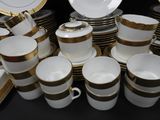 a lot of coffee cups and saucers on the table