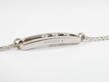 a close up of a silver bracelet with a bar on it