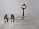 a silver object on a clear table next to a glass vase