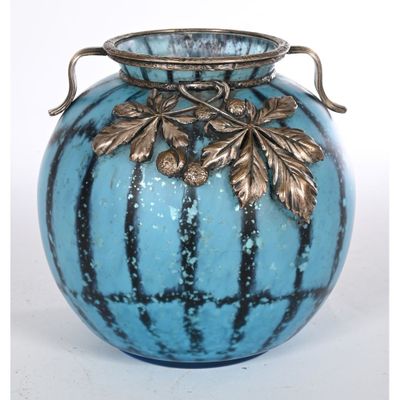 a blue vase with a gold leaf decoration on it
