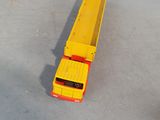 a yellow toy truck that is sitting on the ground