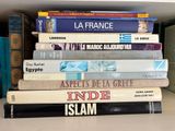 many books stacked on top of each other on a shelf