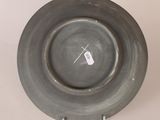a black plate with a tag on it sitting on a table