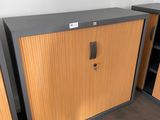 two wooden cabinets in the corner of a room