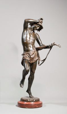 bronze statue of a man holding a bow and arrow on a marble base