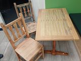two chairs and a table on a wooden floor