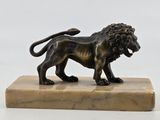 statue of a lion on a marble base on a white background