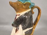 a figurine of a mouse in a suit and hat