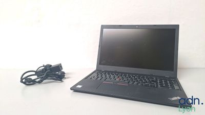 a laptop that is sitting on a table with a charger