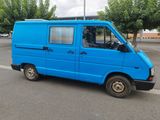 a blue van that is parked on the side of the road