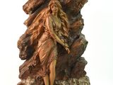 statue of a woman standing on a rock with a dog