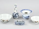 a group of blue and white bowls and a vase