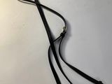 a black leather leash with a gold chain on a white background