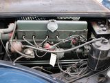 an old car engine with a lot of wires attached to it