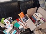 un canapé en cuir noir sur lequel sont posés de nombreux livres