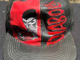 a black and red hat with a picture of a gorilla on it