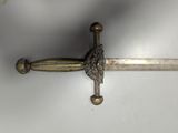 a sword with a bird on it on a white surface