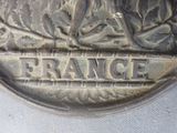 a close up of a silver coin with the word france on it