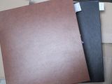two brown folders sitting on top of a cardboard box