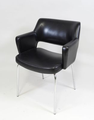 a black leather chair with chrome legs on a white background