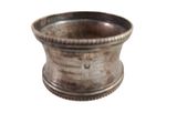 a silver cup that is sitting on a white surface