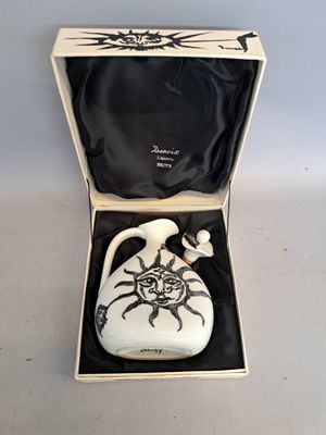 a white vase in a box with a black lid