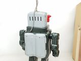 a toy robot that is standing next to a box