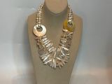 necklace and earring set on a mannequin display in a display case