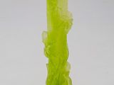 green glass vase with a flower design on the base