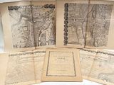 several old maps of paris on display on a table