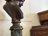 a bust of a woman sitting on top of a table