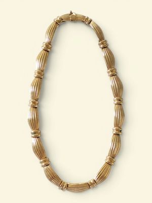 an image of a necklace made out of bamboo sticks on a white surface