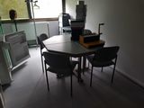a table with chairs and a printer on it in a room