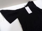 the shirt is black and has a white tag on it
