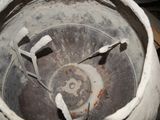 a large metal pot with a hole in the middle of it