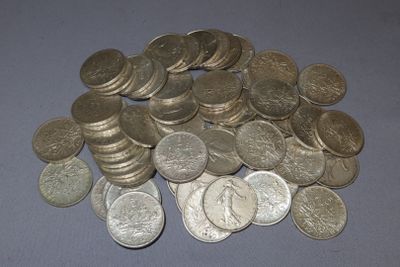 a pile of silver coins on a blue surface
