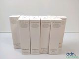 four empty boxes of perfume sitting on a white surface