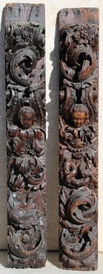 two pieces of wood with carvings on them on a wall