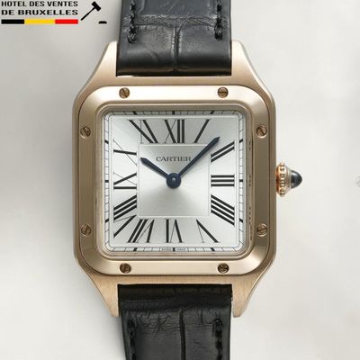une image représentant une montre dorée et noire avec des chiffres romains