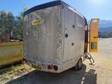 an image of a trailer parked in a dirt lot