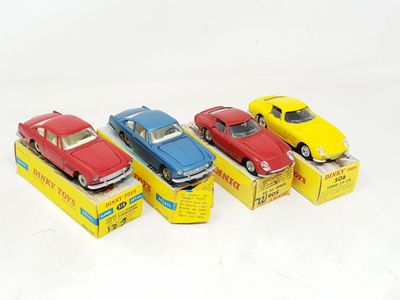 several toy cars are lined up in a row on a white surface