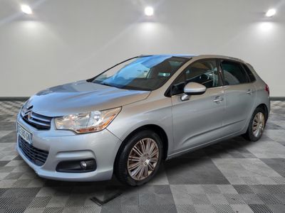 a silver citrole parked on a checkered floor in a garage