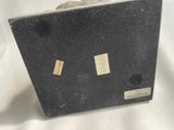 a black suitcase that is sitting on a white surface