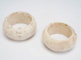 pair of white ceramic bowls on a white surface with a white background