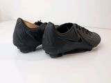 black nike soccer shoes on a white surface with a white background