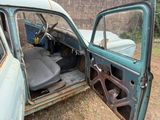 an old car that is sitting in the grass