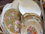 many plates and bowls in a box on the floor